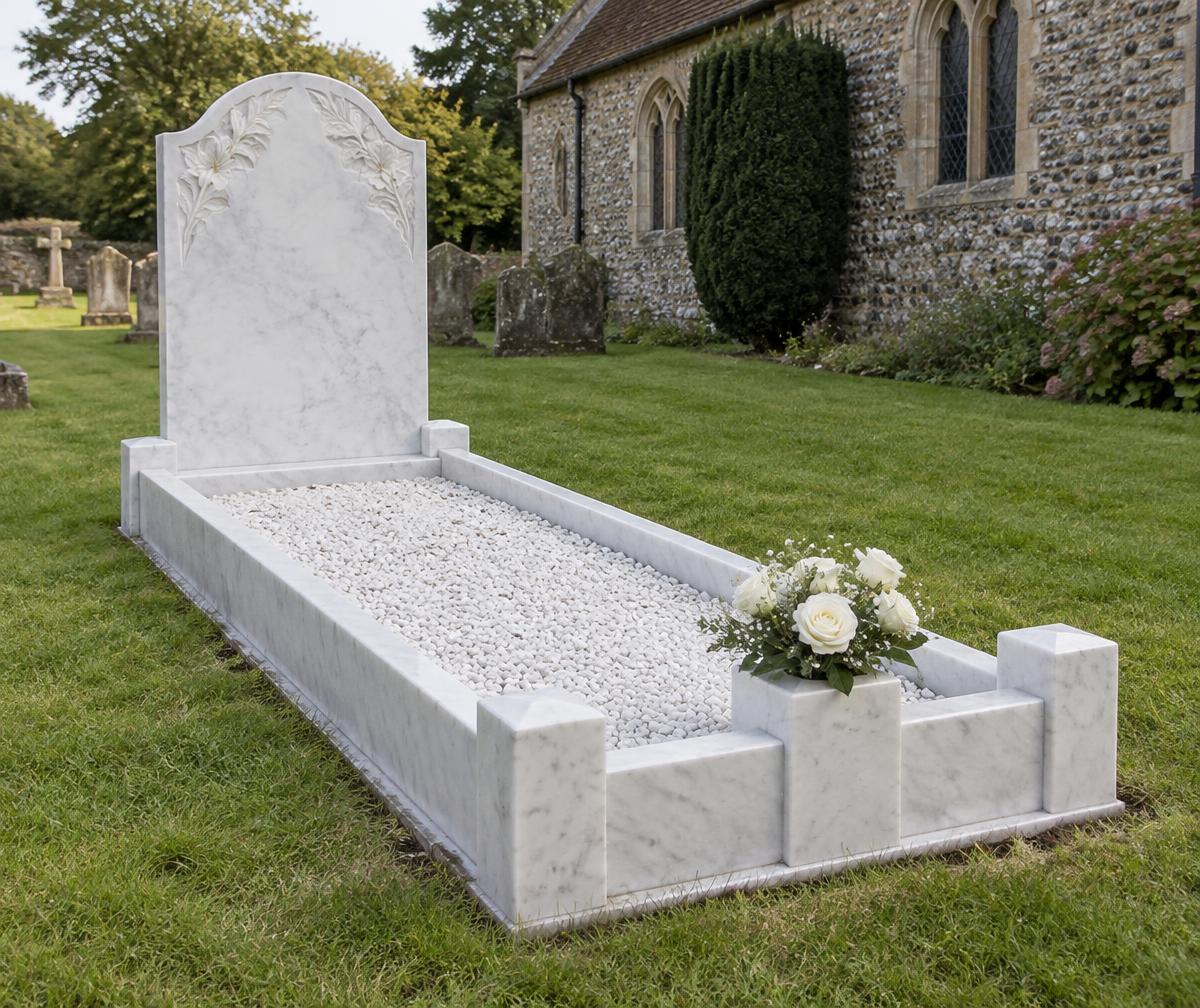 A white marble kerbset memorial with white roses in a churchyard